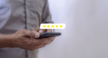 Customer Review, Young Man hand using smartphone mobile with five star to review and give 5 stars...