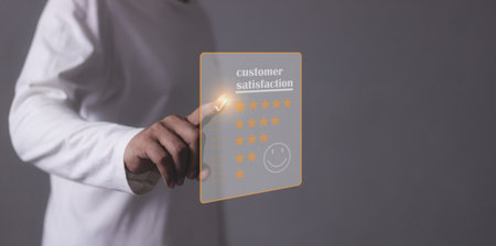 Customer Satisfaction, Young Man hand touching five star to review and give 5 stars with very good results in service, Good review 5 star rating choice feedbackの写真素材