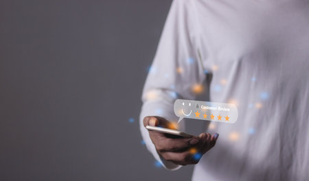 Customer Review, Young Man hand using smartphone mobile with five star to review and give 5 stars with very good results in service, Good review 5 star rating choice feedbackの写真素材