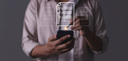 Young man hand holding smartphone mobile using a pen touching to sign a Online Business Contract, Electronic signature, Contract signing, Digital documents, Future smart contractの写真素材