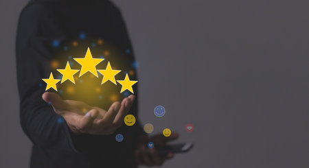 Customer Satisfaction, Young Man with smartphone hand holding five star to review and give 5 stars...