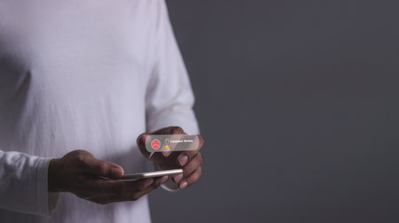 Customer Review, Young man hand holding smartphone to review and gives 1 star, with poor service results, Bad review Rated just 1 star Feedback optionsの写真素材