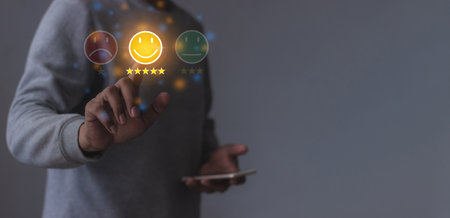 Happy Customer, Young Man using smartphone mobile hand touching emoji five star to review and give 5 stars with very good results in service, Good review 5 star rating choice feedbackの写真素材