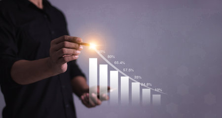 Young man with smartphone mobile hand hold a pen touching to visualize money growth The phone screen...