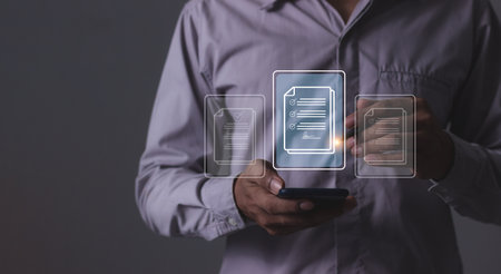 Young man with smartphone mobile hand using a pen touching to sign a Online Business Contract, Electronic signature, Contract signing, Digital documents, Future smart contractの写真素材