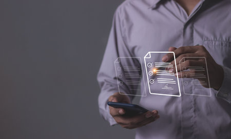 Young man with smartphone mobile hand using a pen touching to sign a Electronic signature, Online Business Contract, Digital documents, Future smart contract, Contract signingの写真素材