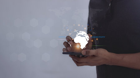 Young man hand uses smartphone touching technology circle, Digital Connectivity, World of communication via modern networks and online systems via the Internetの写真素材