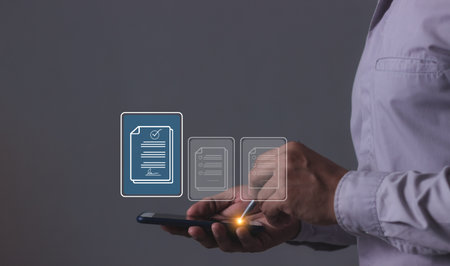 Young man with smartphone mobile hand using a pen touching to sign a Electronic signature, Online Business Contract, Digital documents, Future smart contract, Contract signingの写真素材