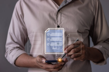 Young man with smartphone mobile hand using a pen touching to sign a Online Business Contract, Electronic signature, Contract signing, Digital documents, Future smart contractの写真素材