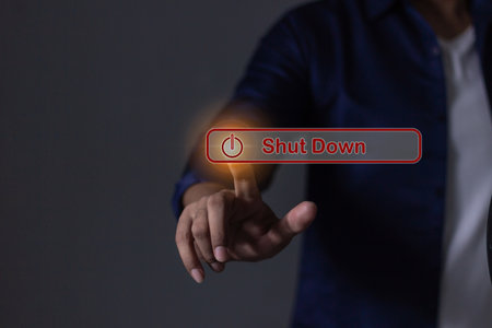 Young man hand touching Shut Down button press power OFFの写真素材
