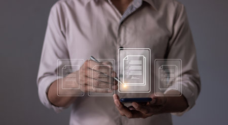 Young man with smartphone mobile hand using a pen touching to sign a Online Business Contract, Electronic signature, Contract signing, Digital documents, Future smart contractの写真素材