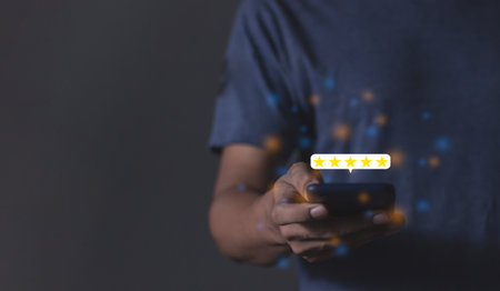 Customer Review, Young Man hand holding Smart Phone with five star to review and give 5 stars with very good results in service, Good review 5 star rating choice feedbackの写真素材