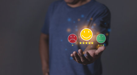 Review Customer, Young Man hand holding emoji five star to review and give 5 stars with very good results in service, Good review 5 star rating choice feedbackの写真素材