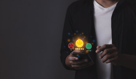 Excellence Review, Young Man hand holding Smart Phone with five star to review and give 5 stars with very good results in service, Good review 5 star rating choice feedbackの写真素材