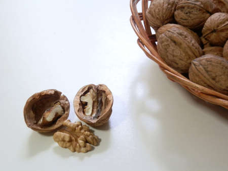 Walnuts in a basket on white backgroundの写真素材