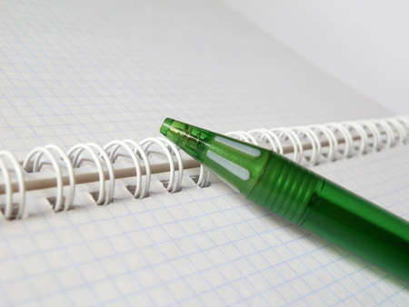 green pen on a notebookの写真素材