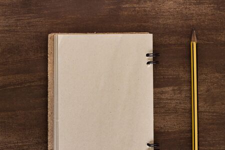old notebook for aiming with pen on wooden table