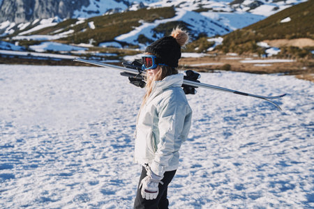 ski carrier pretty girl ready to start skiing in the mountainの写真素材