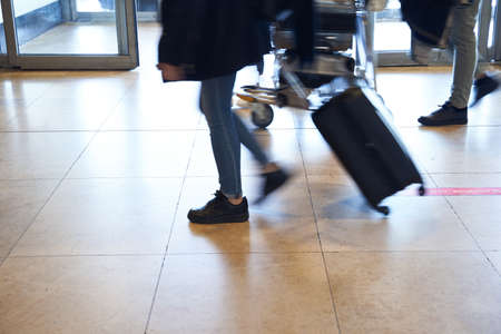 people arriving in airport looking for their pick up. no faceの写真素材