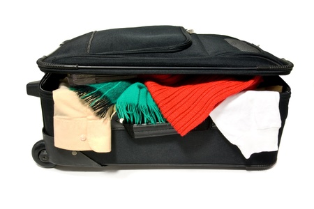 an overstuffed suitcase on a white backgroundの写真素材