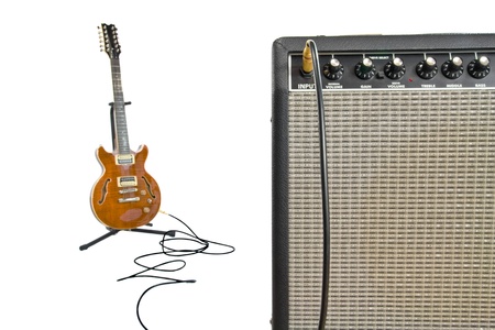 closeup of amplifier and electric guitar in background with cordの写真素材