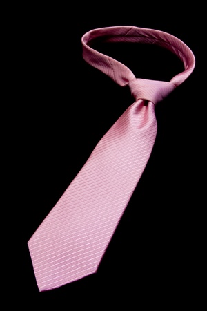 pink necktie isolated on blackの写真素材