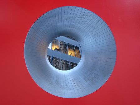  View of office buildings taken through the red cube sculpture on Broadway in the New York Financial Districtの写真素材