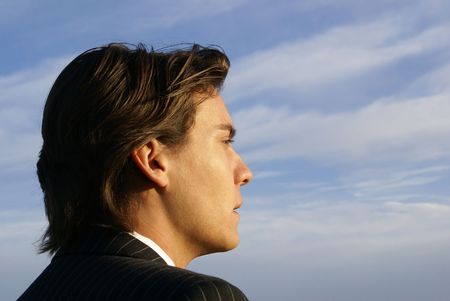 Business Person looking away from  the camera into the Sunsetの写真素材