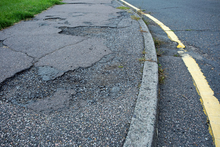 Potholed and broken pavement in Essex UKの写真素材
