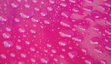 Pink plastic with raindropsの写真素材