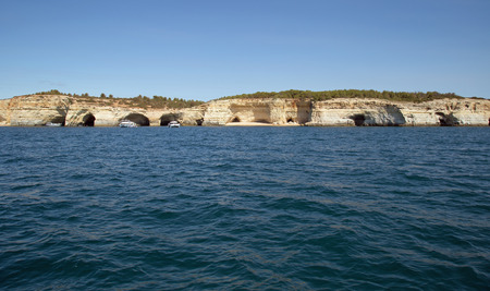 Caves in cliffs on the Algarve coast, Portugalの写真素材