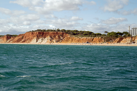 Red cliffs on the Algarve coastの写真素材