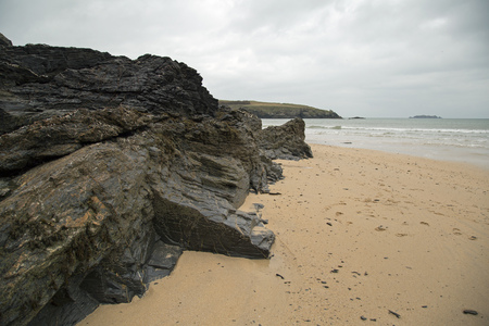 Rocky areas on a sandy Cornish beachの写真素材
