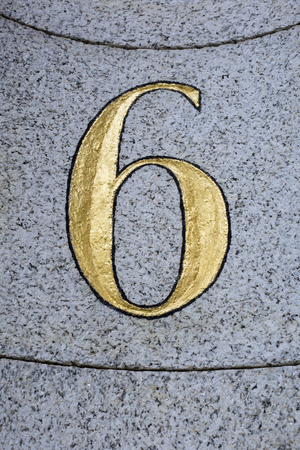 Gilded number 6 chased into stoneの写真素材