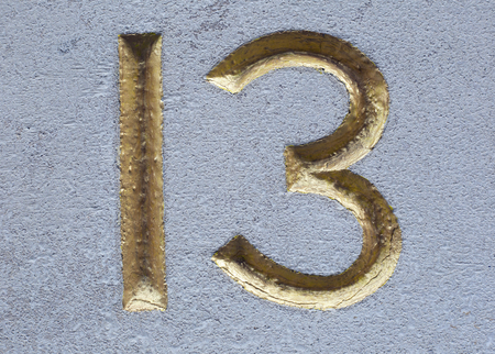 Gilded number 13 chased in stone.の写真素材