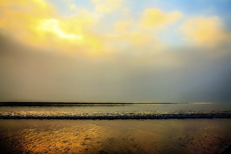 Foggy sunrise colorful sky seascape seaside  beachの写真素材