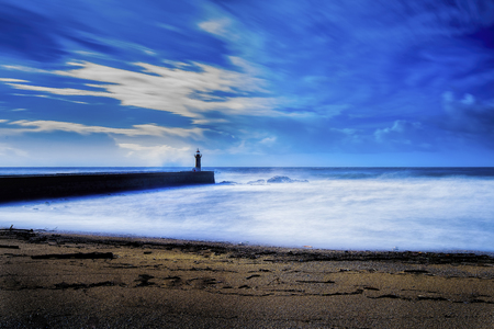 Lighthouse long exposure seascape with milky wavesの写真素材