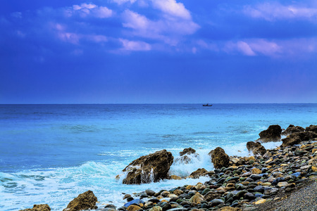 Colorful seascape with fishing boat in backgroundの写真素材