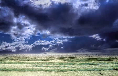 Seascape with choppy seas and puffy cloudsの写真素材