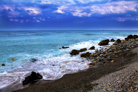 Rocky beach with colorful skies seascapeの写真素材