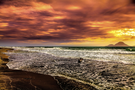 Virgin Kiwi beach with volcano isalnd in backgroundの写真素材
