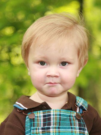 Adorable 12 month old boy with a serious or perplexed expression on his face.の写真素材
