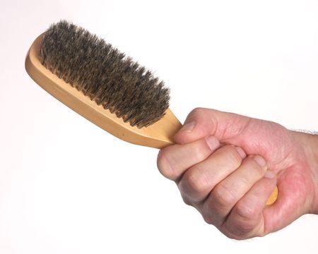 Hand holding hair brush