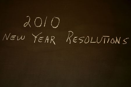 2010 New Year's Resolutions written on blackboard with copy spaceの写真素材