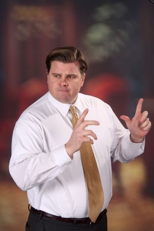 Adult male looks like he is making a point to a jury or a classroom of students.の写真素材