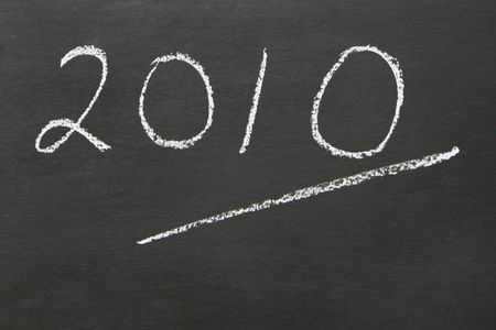 The year 2010 written on a blackboarde with ample copy spaceの写真素材
