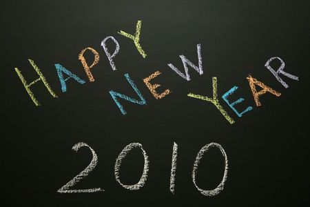 Happy New Year 2010 - written on a blackboard in colored chalkの写真素材