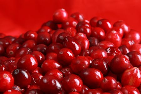 Close up of cranberries on a red background