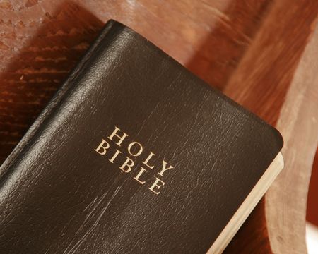 Old Bible laying on a church pewの写真素材