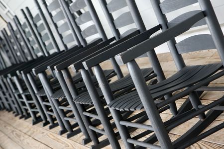 Abstract view of rocking chiars lined up on the porchの写真素材